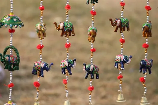 pexels photo 14993860 14993860 Vibrant handcrafted elephant wind chimes with intricate beading, captured in Jaipur, India.